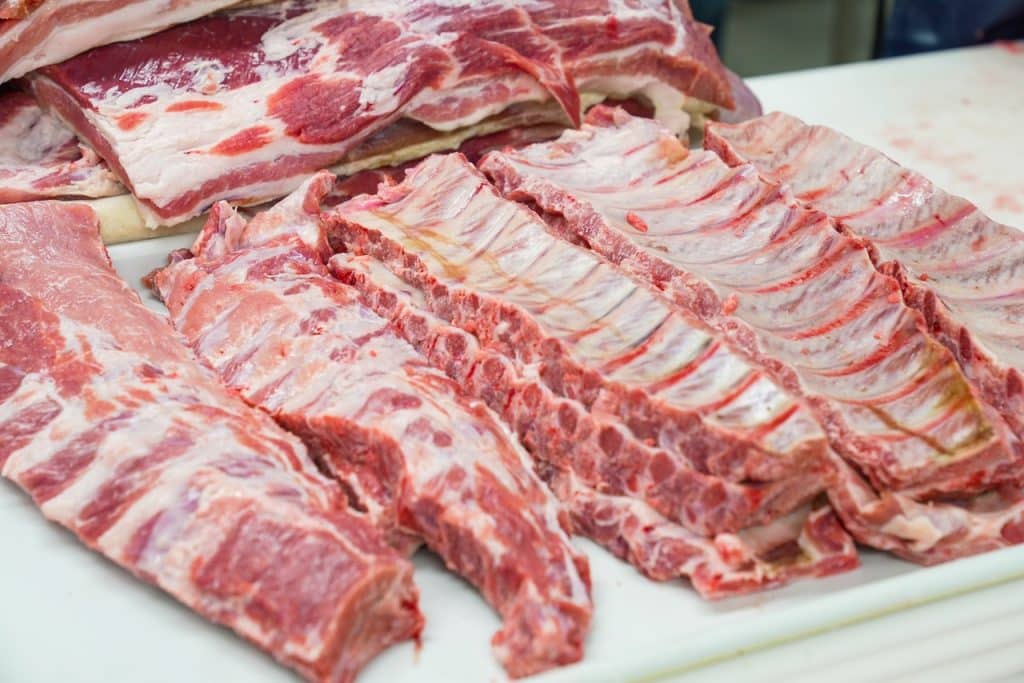 Raw ribs on a white cutting board